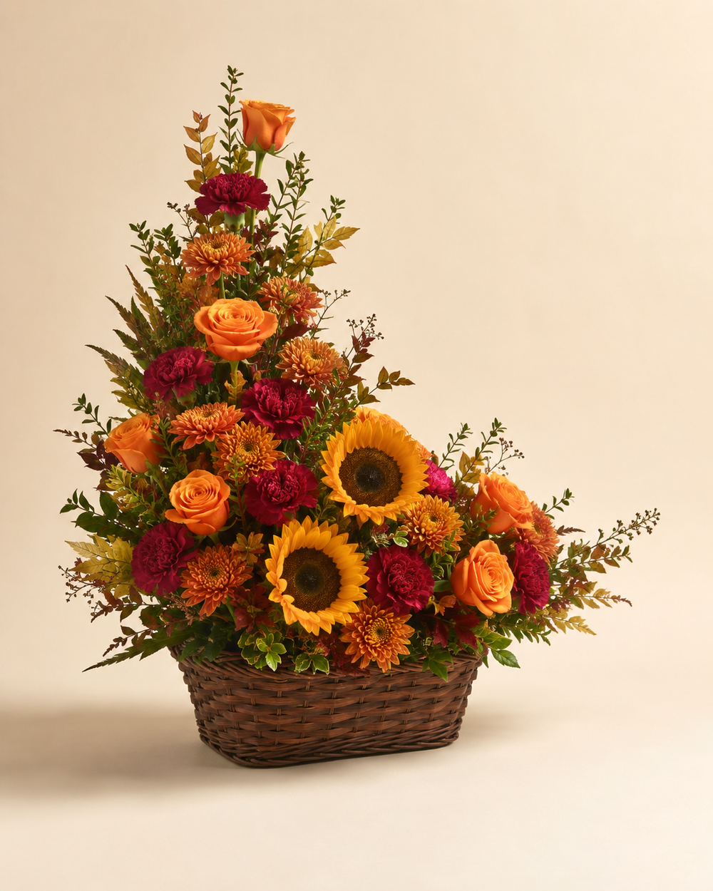 Autumn Hearth sympathy basket with orange roses, bronze mums, sunflowers, and burgundy carnations in a walnut-tone basket
