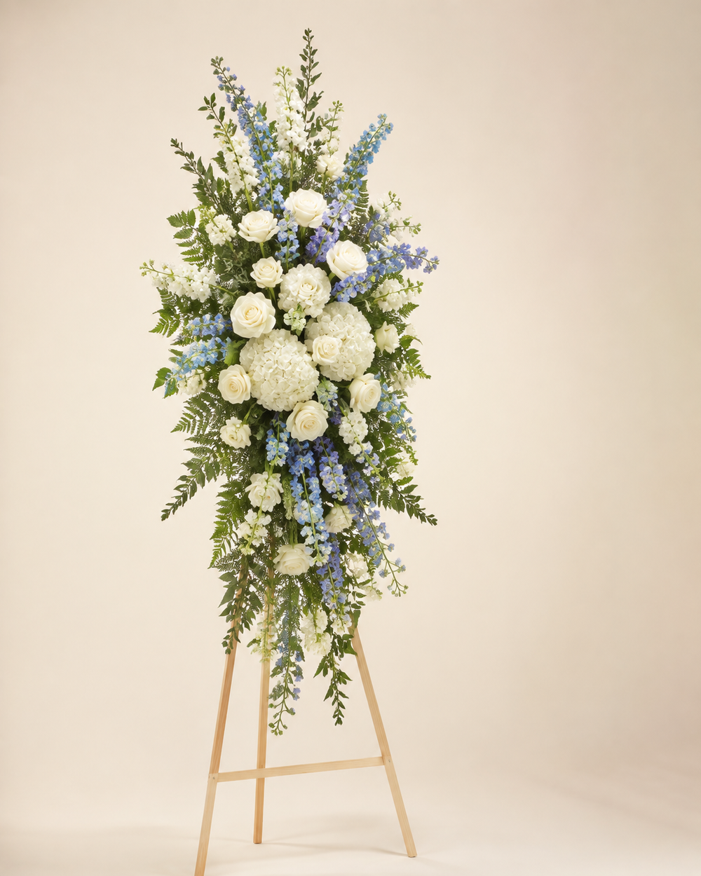 Blue Ridge Sky Spray with white roses, blue delphinium, hydrangeas, and stock