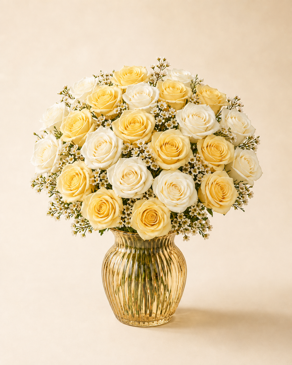 Buttercream Rose Twenty-Four yellow and ivory roses in a pale-gold glass vase