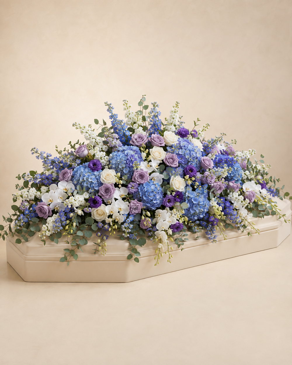 Celestial Garden Full-Casket Spray in lavender, blue, white, and soft green