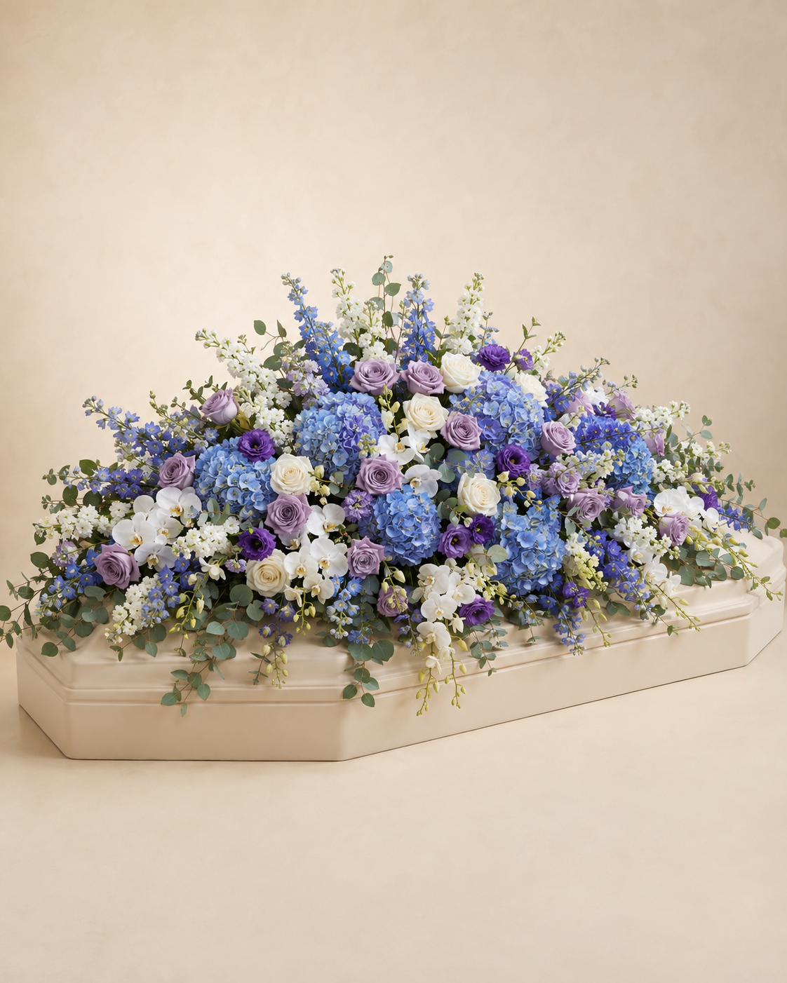 Celestial Garden Full-Casket Spray in lavender, blue, white, and soft green