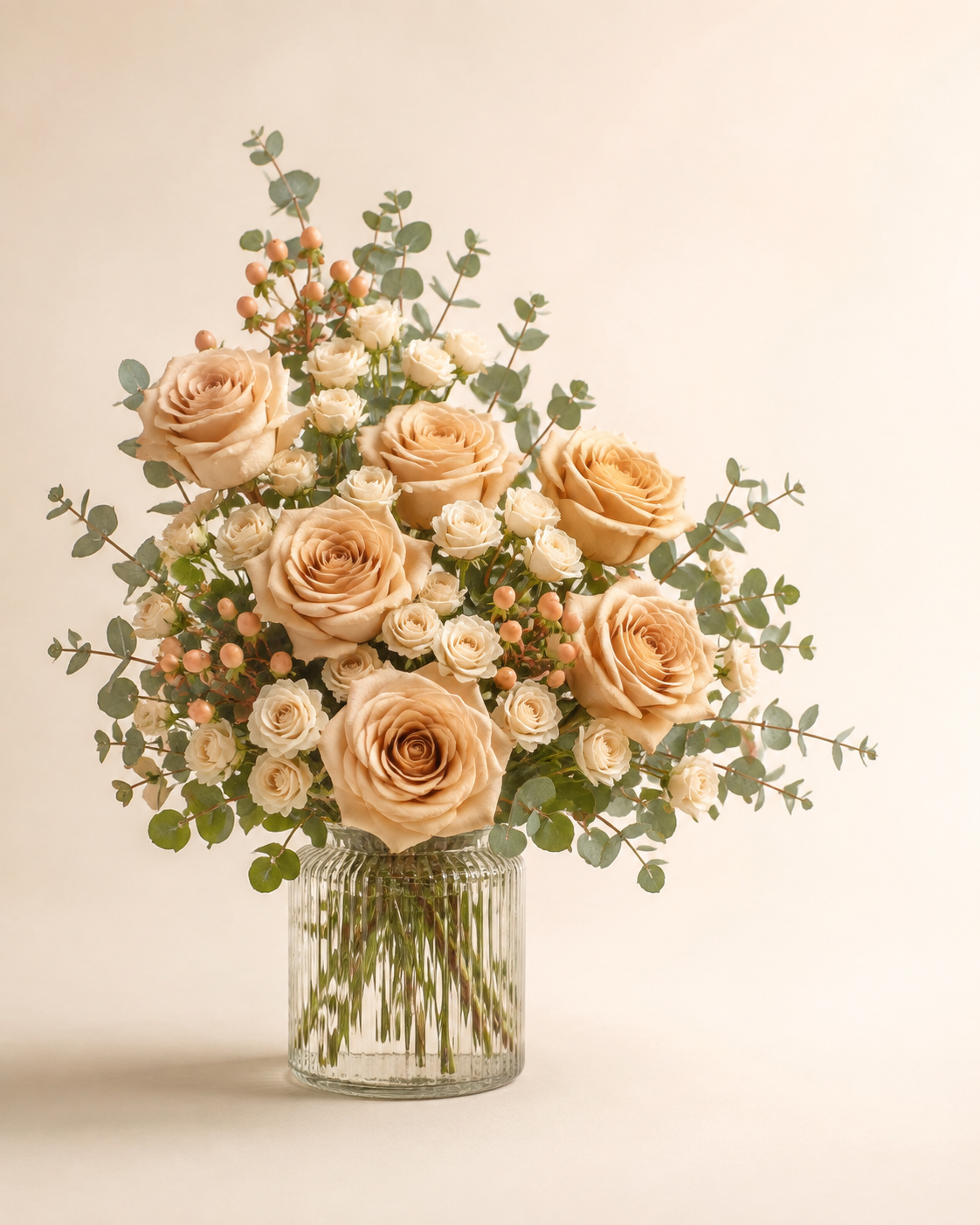 Champagne Rose Ledger with champagne roses in a clear ribbed vase