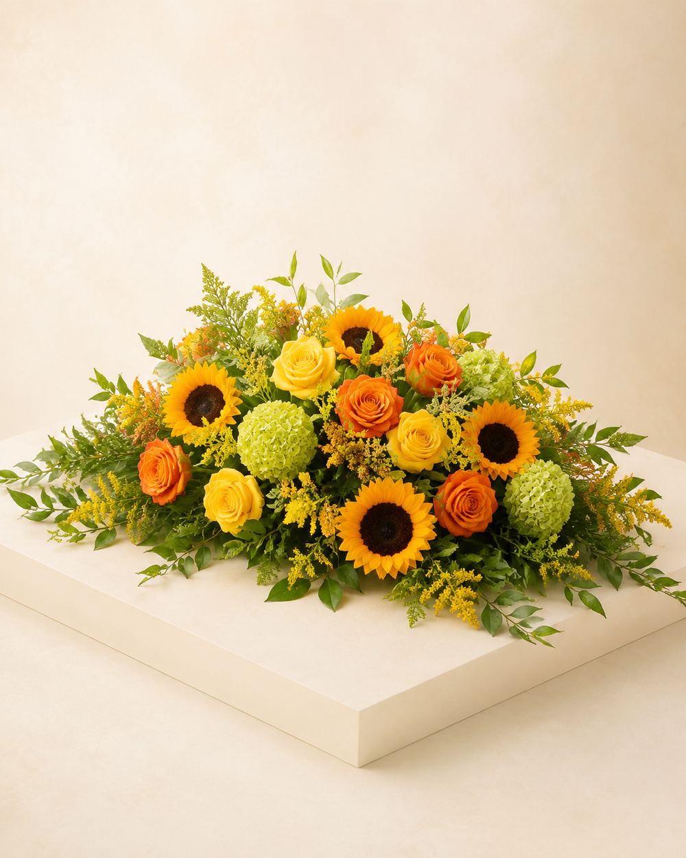 Harvest Light Half-Casket Spray with yellow and orange roses, sunflowers, and green hydrangeas