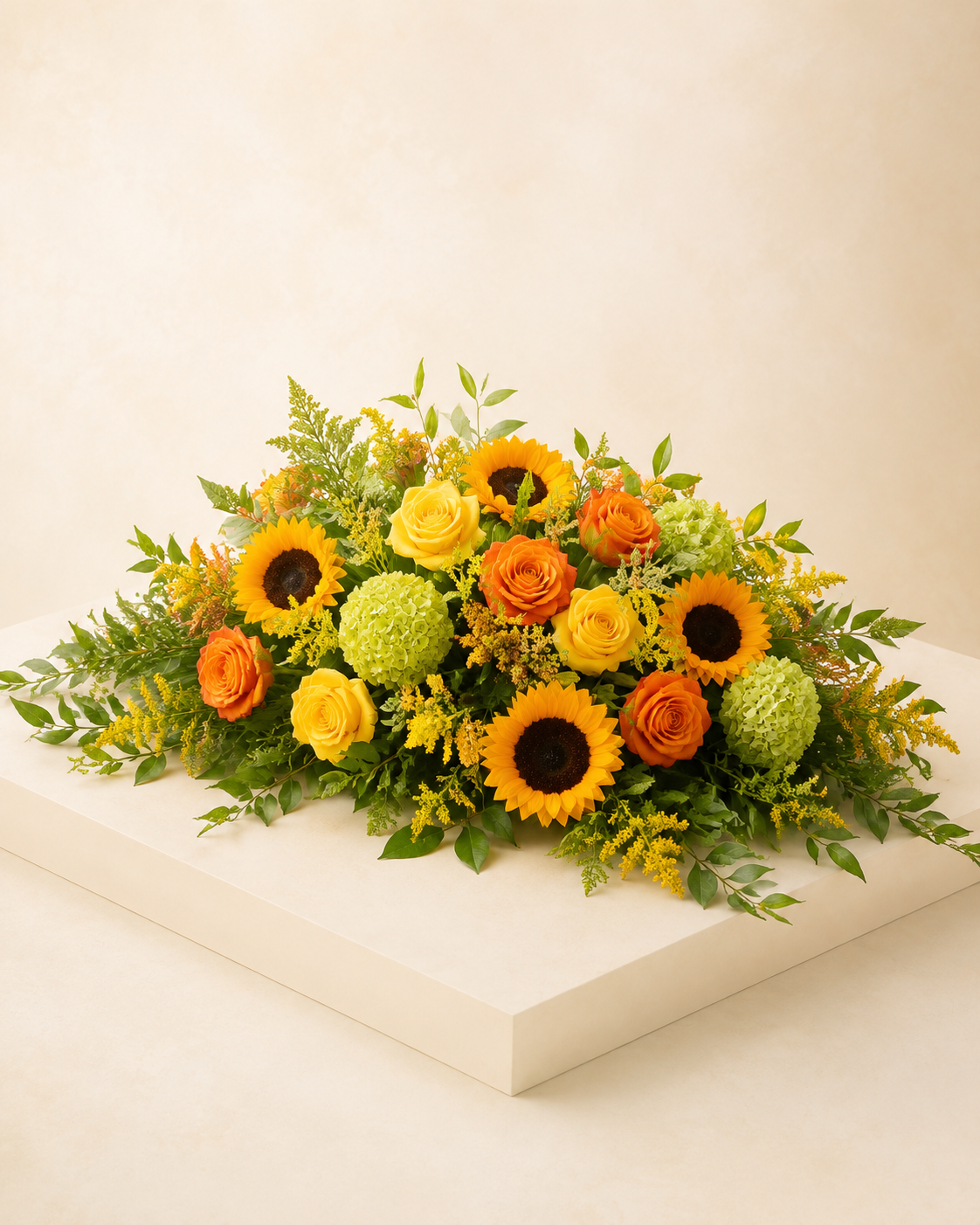 Harvest Light Half-Casket Spray with yellow and orange roses, sunflowers, and green hydrangeas