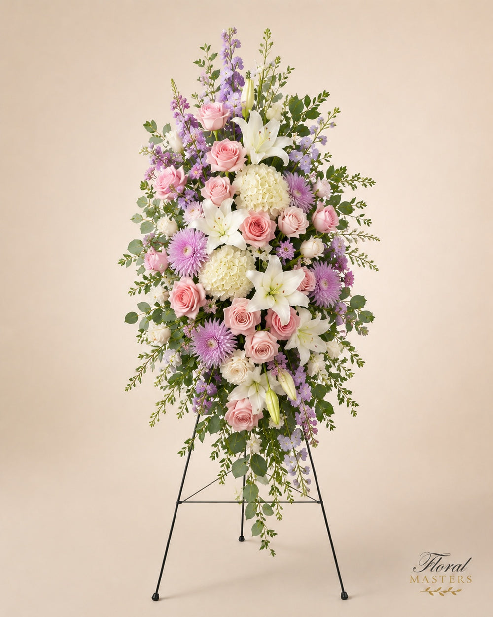 Pink, lavender and white funeral standing spray with roses, lilies and gerbera daisies.