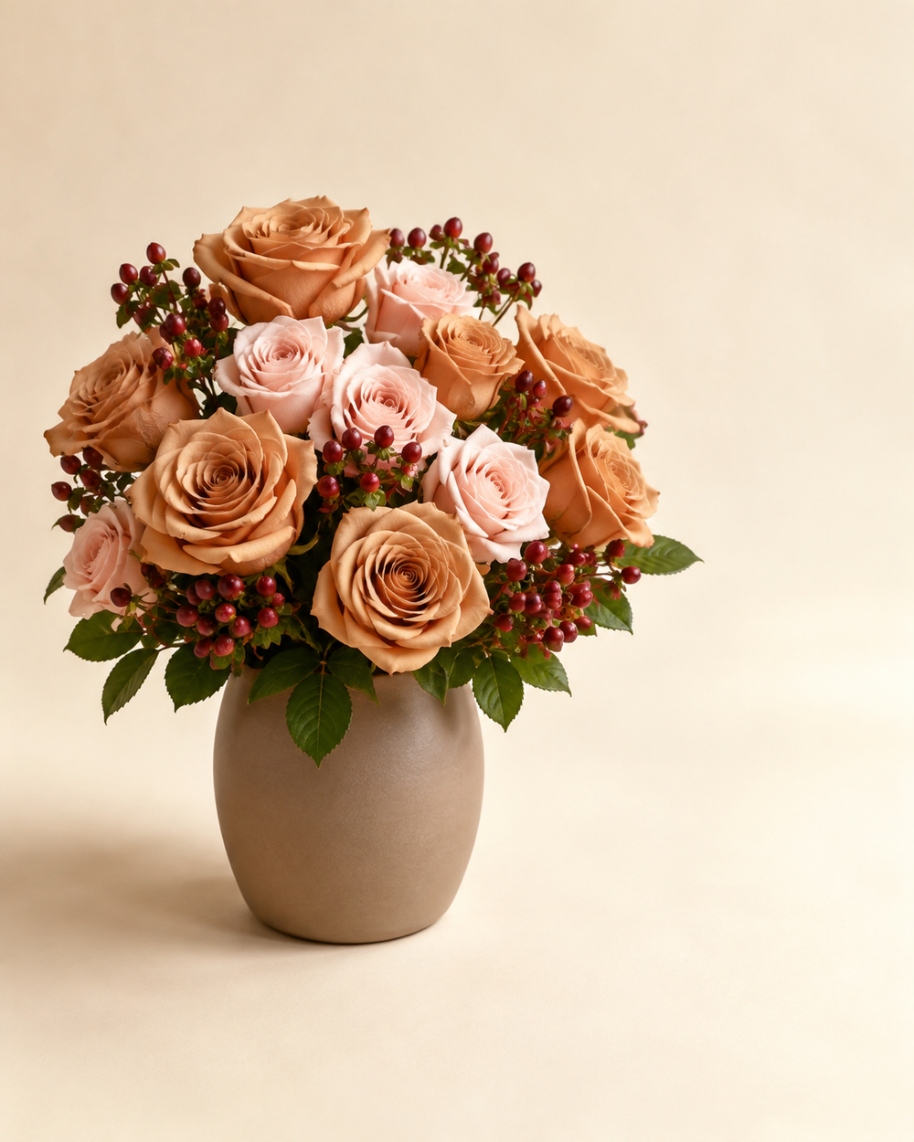 Mocha Blush Rose Garden with cappuccino roses, blush roses, and burgundy hypericum in a taupe ceramic vase