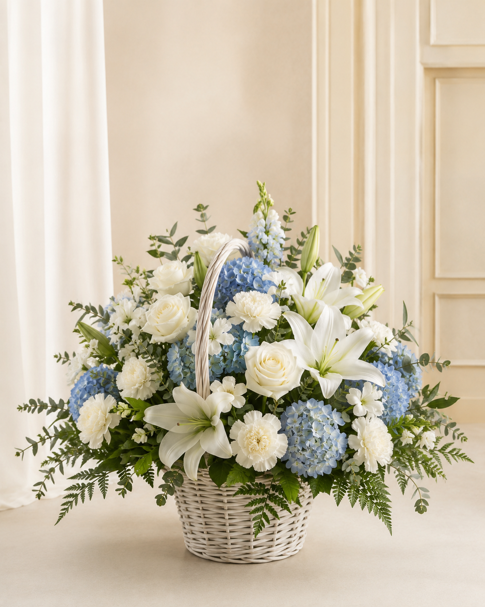 Blue and white sympathy basket with hydrangea lilies roses and white carnations