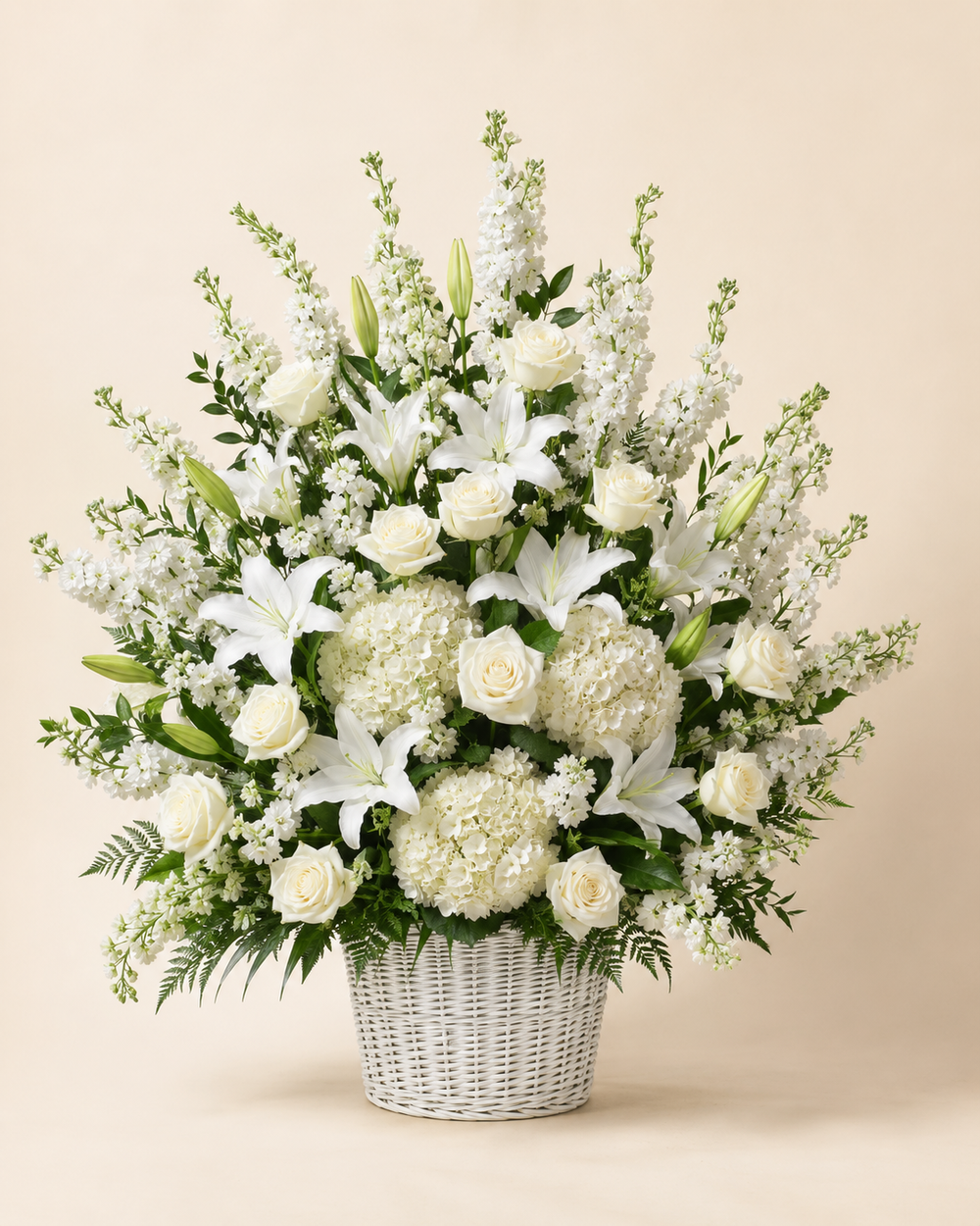 Quiet Garden Floor Basket with white roses, lilies, hydrangeas, and stock