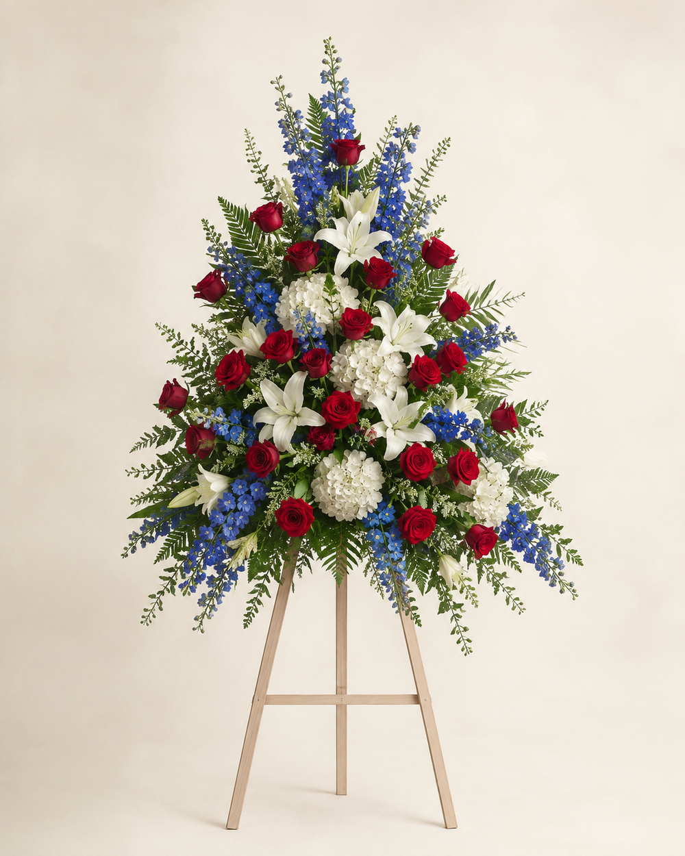 Red White and Blue Service Honor Spray with roses, lilies, delphinium, and hydrangeas