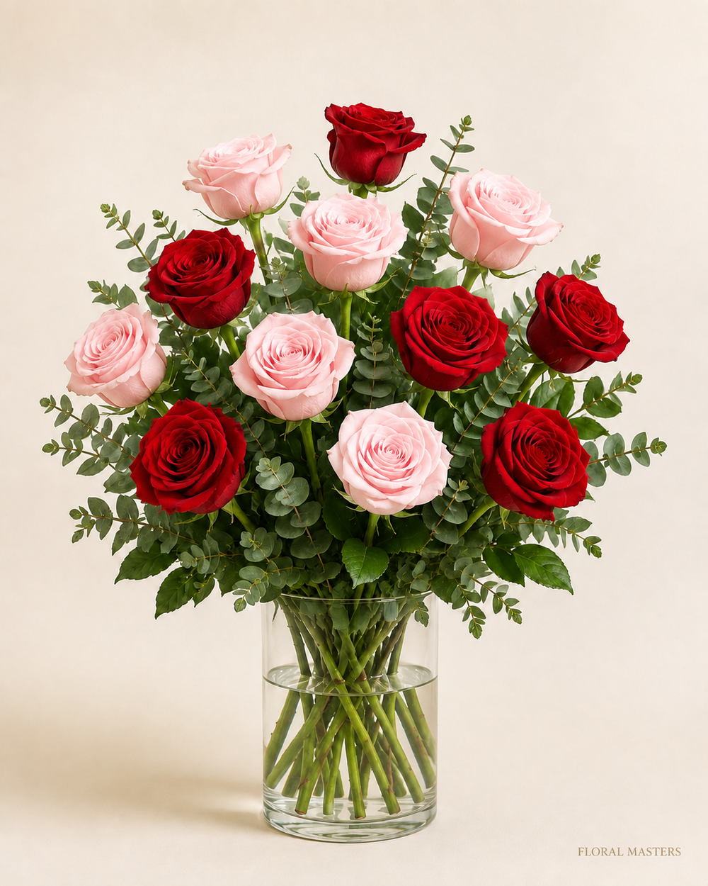 12 red and light pink roses, six of each, in a clear glass vase