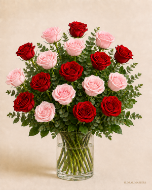 18 red and light pink roses, nine of each, in a clear glass vase