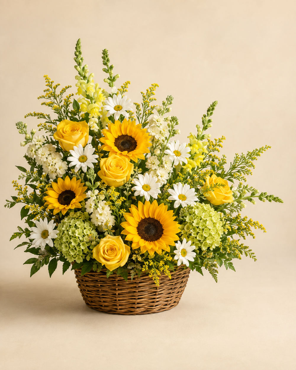 Sunshine Field sympathy basket with yellow roses, sunflowers, white daisies, snapdragons, cream stock, green hydrangea, and solidago in split willow