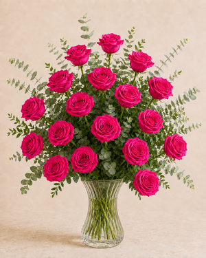 Exactly 18 hot pink roses in a clear fluted hourglass vase